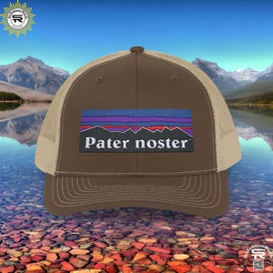 May include: Brown and beige trucker hat with a blue, purple, and red mountain range graphic and the text "Pater noster" on the front.