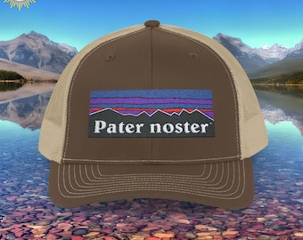May include: Brown and beige trucker hat with a blue, purple, and red mountain range graphic and the text "Pater noster" on the front.