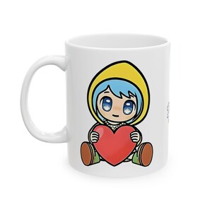 May include: White ceramic mug featuring a cartoon illustration of a girl with blue hair wearing a yellow raincoat and holding a red heart.