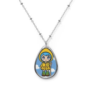 May include: A silver chain necklace with a teardrop-shaped pendant featuring a cartoon girl wearing a yellow raincoat and holding a stick. The background is a blue sky with white clouds.