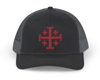 May include: A black and gray trucker hat with a red embroidered Jerusalem Cross on the front.
