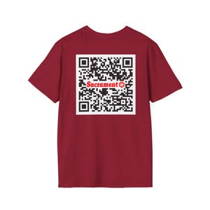 May include: Red t-shirt with a black and white QR code and the word "Sacrament" in red.