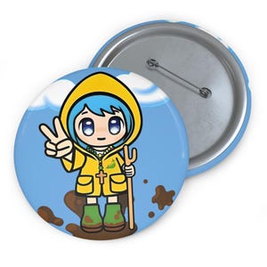 May include: A round button with a cartoon illustration of a character in a yellow raincoat and green boots, holding a wooden staff. The character is making a peace sign with their hand. The background is blue with white clouds and brown mud.