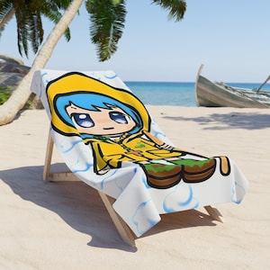 May include: A white beach towel with a cartoon illustration of a girl wearing a yellow raincoat and blue hair. The towel is on a wooden beach chair.