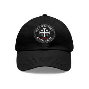 May include: Black baseball cap with a white patch featuring a cross and the text "St. Anthony Catholic Church".