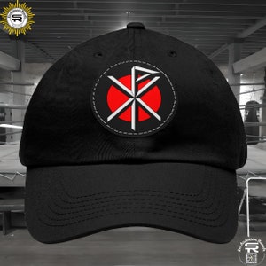 May include: Black baseball cap with a red and white circle logo featuring a stylized cross with a flag on top. The logo is stitched onto the front of the cap.
