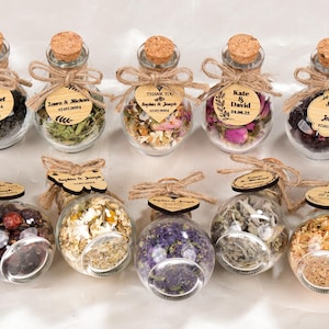 Wedding Tea Favors For Guests, Rustic Wedding Favors, Herbal Tea Favors, Loose Leaf Tea, Tea Party Favor, Bridal Shower, Wedding Guest Gifts

Delight your guests with these charming Wedding Tea Favors — a perfect blend of elegance and nature. Each favor includes a clear glass jar filled with aromatic loose-leaf herbal tea, topped with a natural cork lid and adorned with a rustic twine bow and a personalized wooden tag.