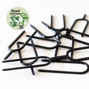 May include: A pile of black plastic SIM card ejector tools. The tools are shaped like a small, thin, flat U.