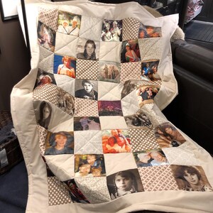 May include: A handmade quilt with a patchwork design, incorporating numerous photographs. The quilt has a white border and backing, with square and triangular patches in neutral tones. The photographs depict people and groups, creating a personalized keepsake.