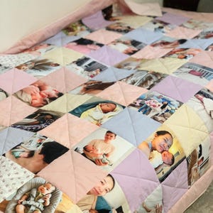 May include: A handmade quilt featuring a patchwork design with various family photos. The quilt is composed of diamond-shaped fabric pieces in pastel colors, including pink, yellow, and blue. The edges are finished with a pink border.