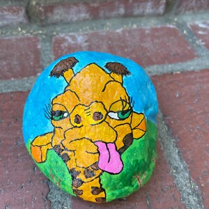 Giraffe painted on rock