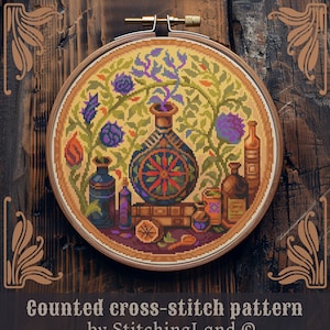 May include: Counted cross-stitch pattern featuring a floral design with a large, ornate vase and several smaller bottles. The vase is decorated with a red and orange wheel design. The pattern is framed in a wooden hoop.