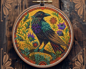 May include: Counted cross-stitch pattern of a black raven with colorful plumage, perched on a branch surrounded by stylized flowers and leaves. The pattern is in a circular hoop, on a wooden background. "Counted cross-stitch pattern by StitchingLand ©" is written below the hoop.