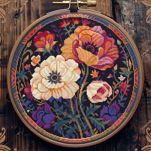 May include: A counted cross-stitch floral design in a wooden embroidery hoop. The flowers are in shades of orange, pink, and white against a dark background. The text "Counted cross-stitch pattern by StitchingLand ©" is at the bottom.