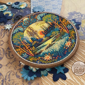 May include: A circular cross-stitch embroidery depicting a colorful landscape with trees, water, and a sunset. The embroidery is framed in a wooden hoop with a decorative edge. The text "Stitching Land" is visible in the lower right corner.