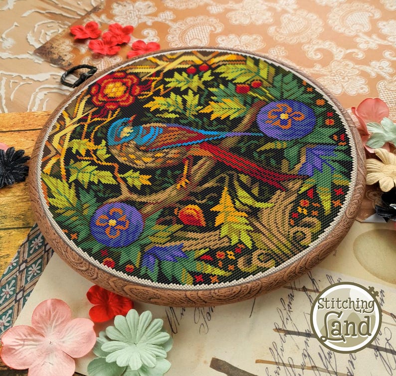 May include: A colorful cross-stitch embroidery of a bird perched on a branch surrounded by flowers and leaves. The embroidery is framed in a wooden hoop.