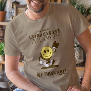 May include: A tan t-shirt with a brown graphic of a smiley face wearing a top hat and the text "...are these EXTRAVAGANT PROMISES? WE THINK NOT!"