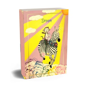 May include: A yellow and pink illustration of a zebra with a monkey and a small monkey riding on its back. The zebra is running through the clouds with a rainbow and a sun in the background. The word "Dream" is written in the top right corner of the image.