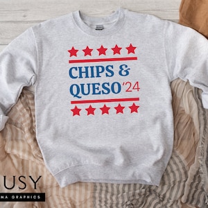 May include: Gray sweatshirt with a blue and red graphic that says "Chips & Queso '24" with five red stars above and below the text.