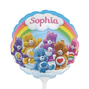 May include: A round, colorful balloon featuring the Care Bears characters, a rainbow, and the name "Sophia" in pink. The balloon has a white stem and is decorated with various Care Bears in different colors.