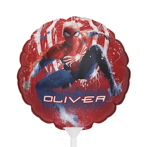 May include: A round, red balloon featuring Spider-Man in a dynamic pose against a red and white splatter background. The name "OLIVER" is printed in white block letters across the bottom. The balloon is attached to a white plastic stick.