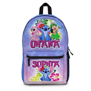 May include: A blue backpack featuring the characters Stitch, Angel, and Lilo from the movie Lilo & Stitch. The word "OHANA" is displayed above the characters, and the name "SOPHIA" is below. The backpack has a black handle and a side pocket.