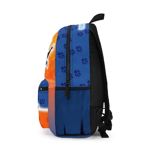 May include: A blue and orange backpack with a black back and straps. The backpack features a paw print pattern on the blue side and a graphic design on the orange side. A small pocket and mesh side pocket are visible.