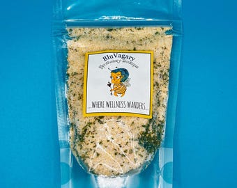 May include: A clear plastic bag filled with a yellow and green seasoning blend. The bag has a label that says "Blu Vagary Apothecary Boutique...where wellness wanders."
