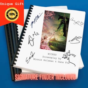 May include: A white notebook with a black spiral binding. The notebook has a poster of the movie "Wicked" on the front. The poster features two women, one in green and one in pink, with a green background. The notebook also has several signatures on the front, including "Wicked" and "Screenplay by Winnie Holzman & Dana Fox". The notebook has a red stamp that says "Satisfaction 100%".