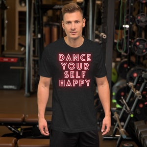 May include: A black t-shirt with the text "DANCE YOUR SELF HAPPY" in red neon lettering.