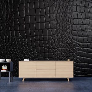 May include: A black crocodile-textured wall covering dominates the scene, complemented by a light wood-toned cabinet with three doors and a small side table. The side table holds a clock and two white bowls.