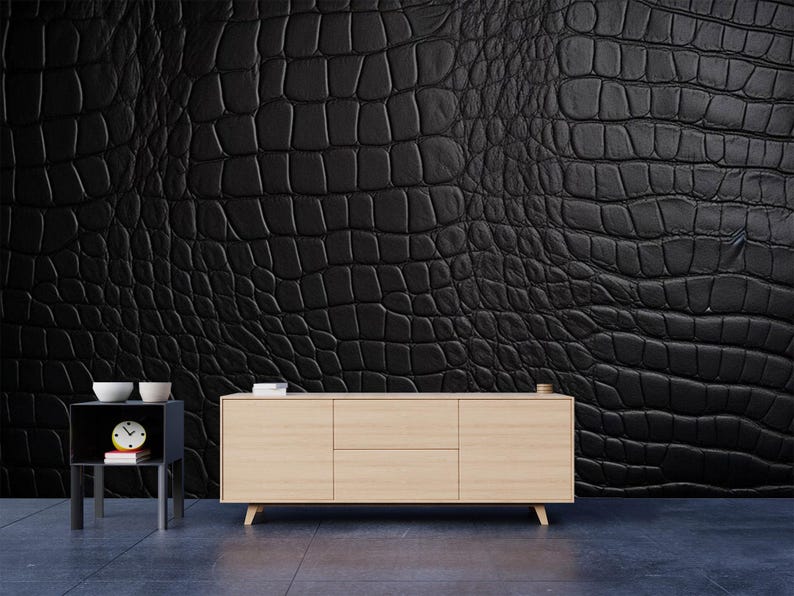May include: A black crocodile-textured wall covering dominates the scene, complemented by a light wood-toned cabinet with three doors and a small side table. The side table holds a clock and two white bowls.