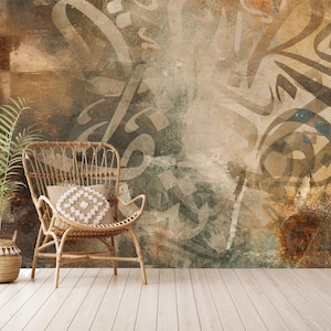 May include: A decorative interior scene featuring a woven wicker chair with a patterned pillow, a potted plant, and a textured wall with abstract calligraphy. The floor is made of light-colored wooden planks.