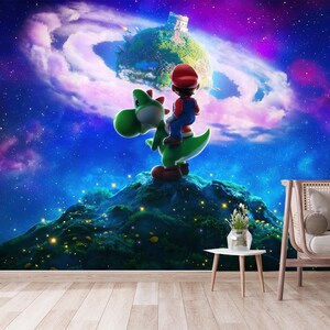 May include: A colourful wall mural depicting Mario riding Yoshi on a green hill, set against a starry, purple and blue galaxy backdrop. A small planet with a castle floats in the background. A couch and table are in the foreground.
