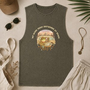 Tank top with a frog working on a laptop next to a van, text "WE WORK FROM ANYWHERE AT DAWN."