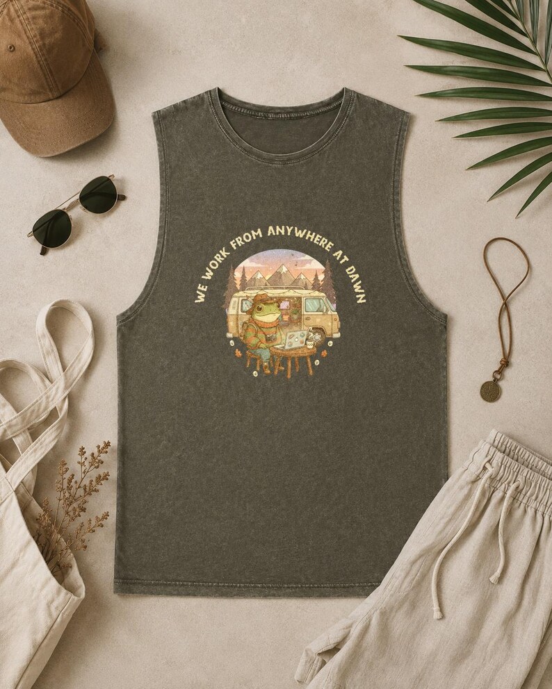 Tank top with a frog working on a laptop next to a van, text "WE WORK FROM ANYWHERE AT DAWN."