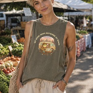 Green graphic tank top with a frog and van illustration and text "We Work From Anywhere At Dawn".
