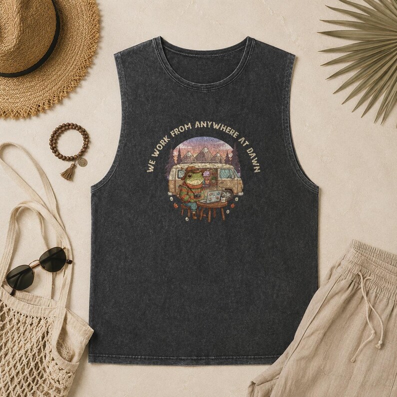 Dark grey tank top with a frog working on a laptop next to a van, "WE WORK FROM ANYWHERE AT DAWN" text.