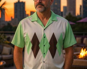 May include: A short-sleeved button-down shirt featuring a light green and white color scheme with a prominent dark brown and light green diamond argyle pattern on the front, a classic collar, and a straight hemline worn with black trousers.