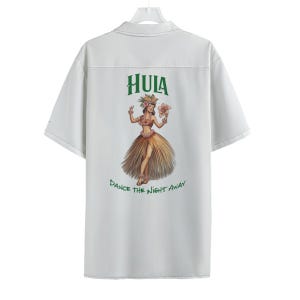 May include: White short-sleeved button-up shirt with a green "HULA" graphic and a hula dancer illustration. The text below the illustration reads "DANCE THE NIGHT AWAY".