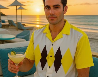 May include: A yellow and white button-down shirt with a diamond pattern. The shirt is worn by a person holding a cocktail with a lime garnish. The background shows a beach scene at sunset.