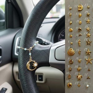 May include: A gold-colored car charm featuring a crescent moon and sun pendant with a small chain of light blue beads, hanging from a car steering wheel. A collection of gold-colored seashell charms are displayed on a gray surface.