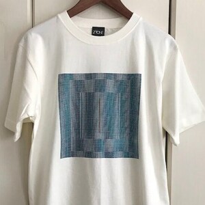 May include: White t-shirt with a blue and white pixelated design and the word "ZIO" printed on the front.