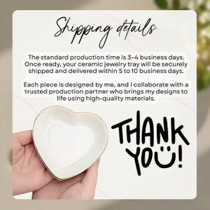 May include: A white ceramic heart-shaped jewelry tray with a gold rim. The tray is held in a person's hands. The words "Thank You!" are written in black. The text "Shipping details" is also visible.