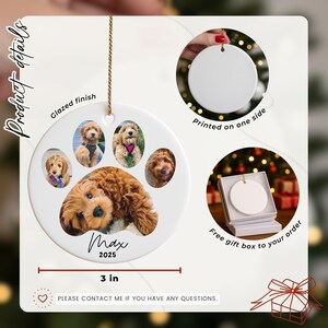 May include: A white ceramic paw-shaped ornament with a glazed finish, featuring photos of a dog and the name "Max" and the year "2025". The ornament is 3 inches in diameter and includes a gift box.