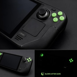 May include: Black Steam Deck with glow-in-the-dark green buttons. The image shows the device and individual buttons, with text that reads "GLOW IN THE DARK BUTTONS FOR STEAM DECK". The buttons glow after dark.