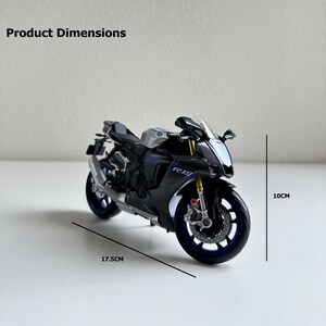 May include: A black and silver model motorcycle with blue accents. The model is 17.5 cm long and 10 cm high. The motorcycle has the letters "RM" on the side. The product dimensions are displayed in the image.
