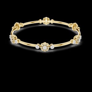 May include: A gold bangle bracelet with floral and round diamond accents. The bracelet features a series of flower-shaped designs and small, round diamonds set along the band. The bracelet is displayed against a black background.