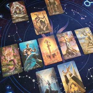 a collection of tarot cards arranged on a starry background.