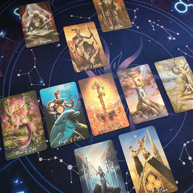 a collection of tarot cards arranged on a starry background.